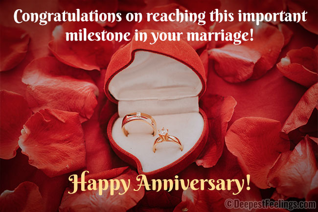 Happy Anniversary wishes card with a background of petals of roses and wedding rings