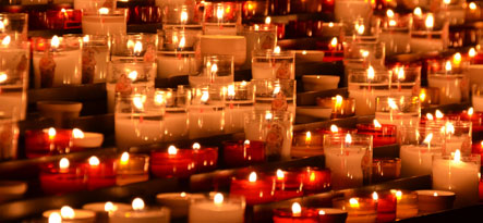 All Saints' Day wishes card with a background of lighted candles